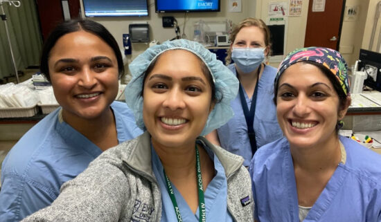 Dr. Nisha Verma surrounded by healthcare professionals
